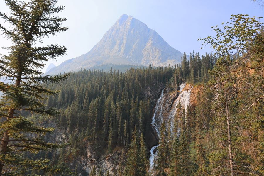 mountain and waterfall landscape along the moderate hiking trail at Grassi Lake in Canmore, Alberta, Canada
