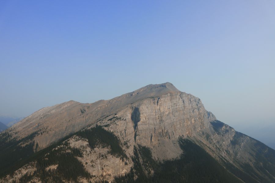 view of a hazy morning Mount Rundle along the ascent of Ha Ling Peak trail in July 2021