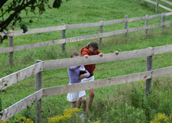 Kaitlyn and Tasha climbing a fence